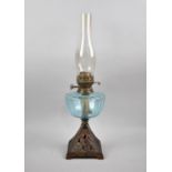 A Late Victorian Iron Base Oil Lamp with Blue Glass Reservoir and Chimney, Dual Controls, 55cm high