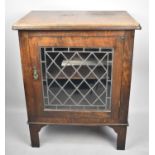 An Oak Music Cabinet with Lead Glazed Panelled Door