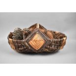 An Oval Wicker Flower Trug Containing Pine Cones