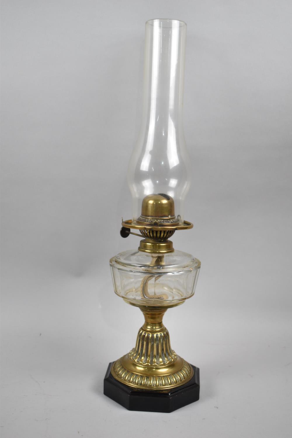 A Late Victorian Brass Based Oil Lamp with Octagonal Plinth Base and Glass Reservoir, Complete