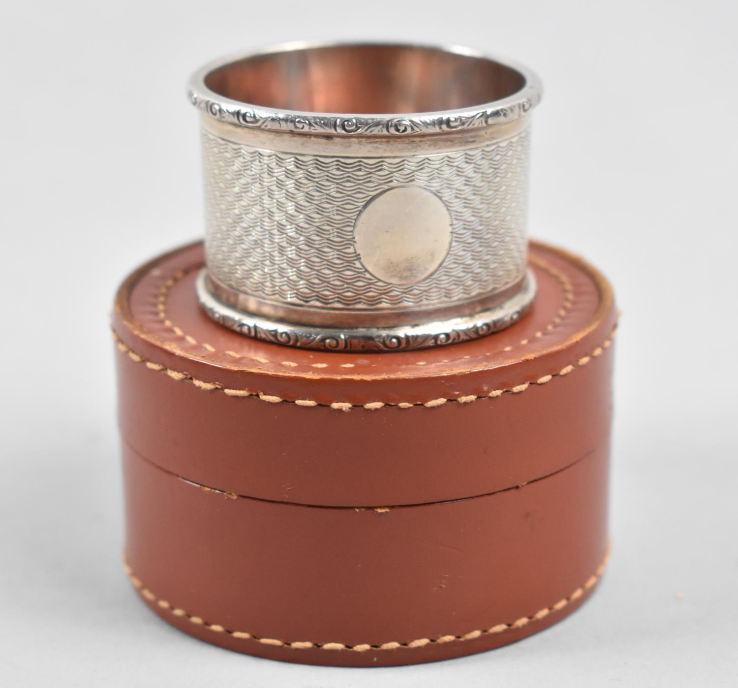 A Leather Gents Stud Case Containing Unrelated Silver Napkin Ring with Engine Turned Decoration,