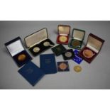 A Collection of Vintage Cased Coins and Medallions