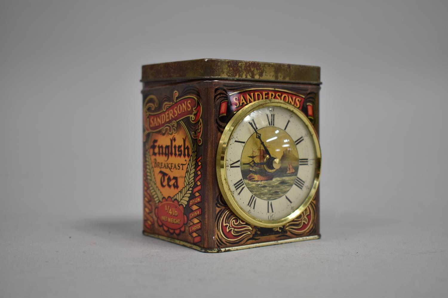 A Novelty Tea Caddy with Clock Mounts, Complete with Caddy Spoon and Original Printed