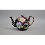 A Late 19th Century Floral Decorated Miniature Teapot on Black Glazed Ground, 9cm high