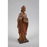 A Continental, Probably French Carved Wooden Study of Bishop with Model of Church, Staff and