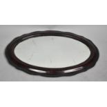 A Mid 20th Century Oval Mahogany Framed Wall Mirror, 83x56cm
