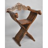 A Mid 20th Century Italian X Framed Armchair with Carved Top and Lion Mask Handles