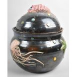 A Continental Glazed Terracotta Fish Soup Tureen, Decorated in Relief with Jellyfish, Seashells,
