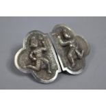 A Far Eastern White Metal Belt Buckle decorated in Relief with Thai Dancers
