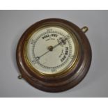 An Edwardian Oak Wall hanging Aneroid Barometer, 26cms Diameter