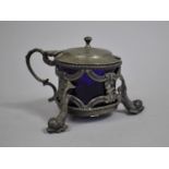 A Britannia Metal Mustard Pot with Three Dolphin Supports and Cobalt Blue Glass Liner, 8cms High