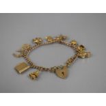 A 9ct Gold Charm Bracelet with Various 9ct Gold Charms and One 18ct Gold Example, 9ct Gold Charms to
