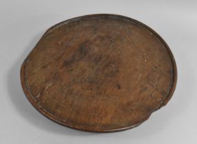 An Early Circular Wooden Charger on Three Later Turned Supports, 29cms Diameter