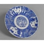 A Japanese Blue and White Plate of Reeded Form, 21cms Diameter