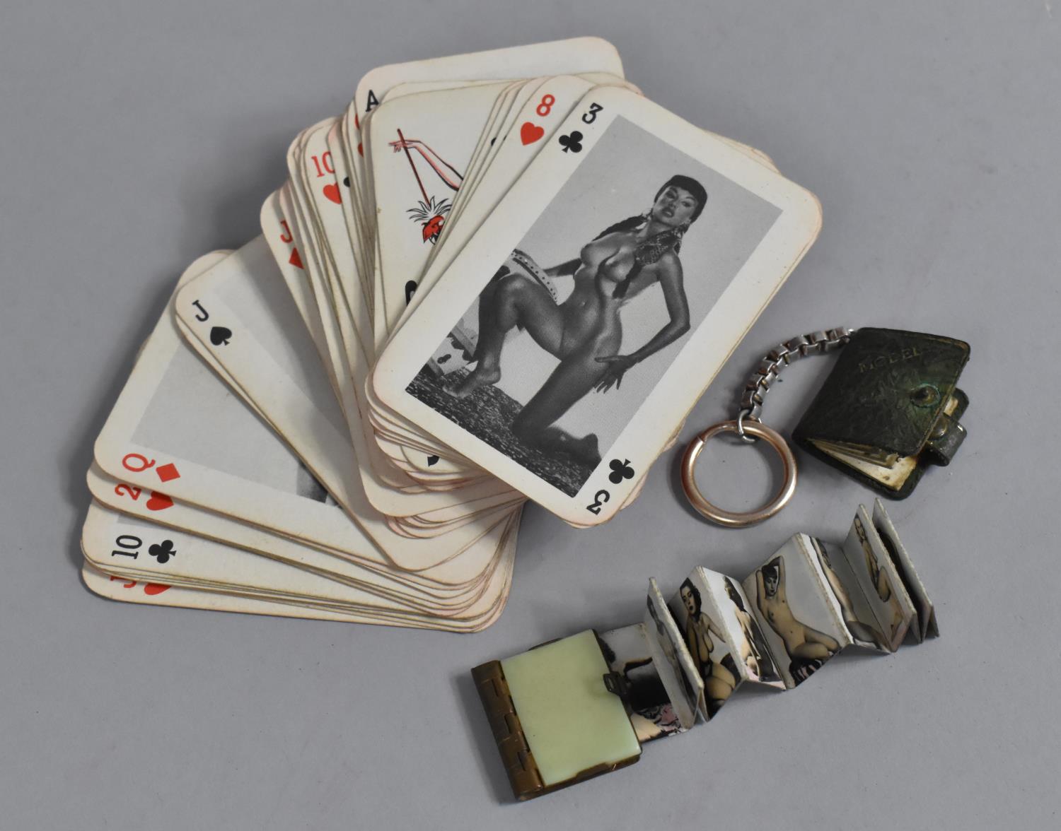 A Pack of What Butler Saw Playing Cards together with two Vintage Novelty Keyring Books containing