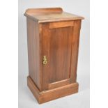 An Edwardian Galleried Bedside Cabinet with Panelled Door Having Brass Handles to Shelved