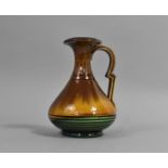 A Brown and Green Majolica Glazed Jug in the Manner of Christopher Dresser, 15cm high