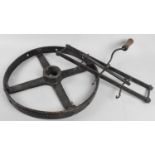 A Vintage Cast Iron Pulley Wheel and Three Hook Frame