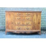 A Mid 20th Century Bow Fronted Yew Wood Sideboard with Four Graduated Centre Drawers Flanked by