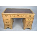An Edwardian Pine Kneehole Desk with Tooled Leather Top, Centre Drawer Flanked by Two Drawers and