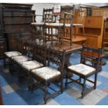 An Ercol Oak Rectangular Drawer Leaf Dining Table with Carved Border Together with Eight Ercol