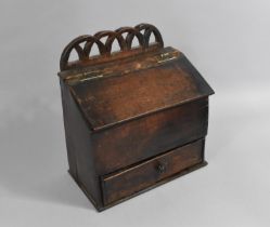 An 18th Century Oak Candlebox with Fretwork Back, Hinged Sloping Lid and Single Base Drawer, 30cm
