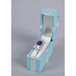 A Ladies Silver Dress Ring with Blue Stone and White Chips Stamped 925