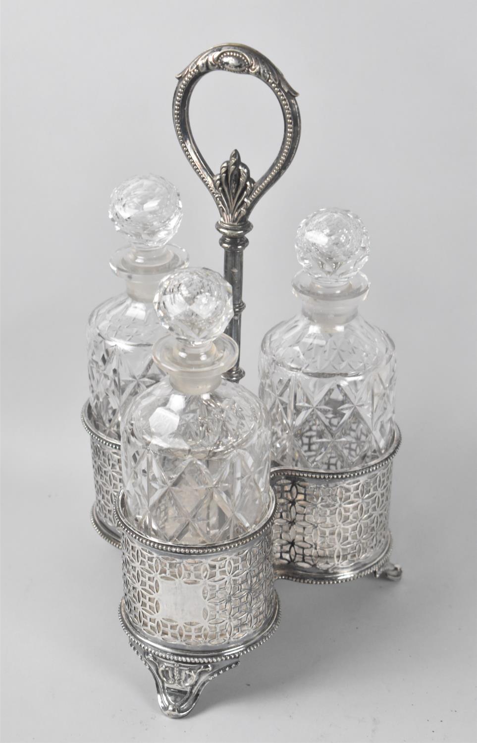 A Victorian Silver Plated Decanter Carrier with Three Cut Glass Bottle Decanters, by Martin Hall &