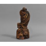 A Chinese Carved Wooden Figure, Immortal in Robe upon Rock, 17cms High