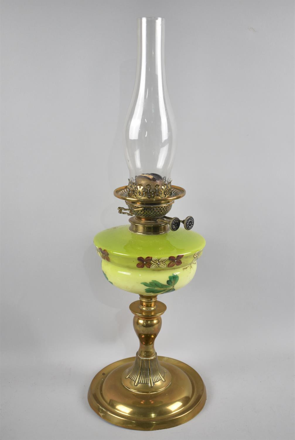 A Late 19th/Early 20th Century Brass Oil Lamp with Enamelled Opaque Glass Reservoir decorated with