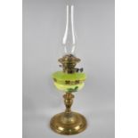 A Late 19th/Early 20th Century Brass Oil Lamp with Enamelled Opaque Glass Reservoir decorated with