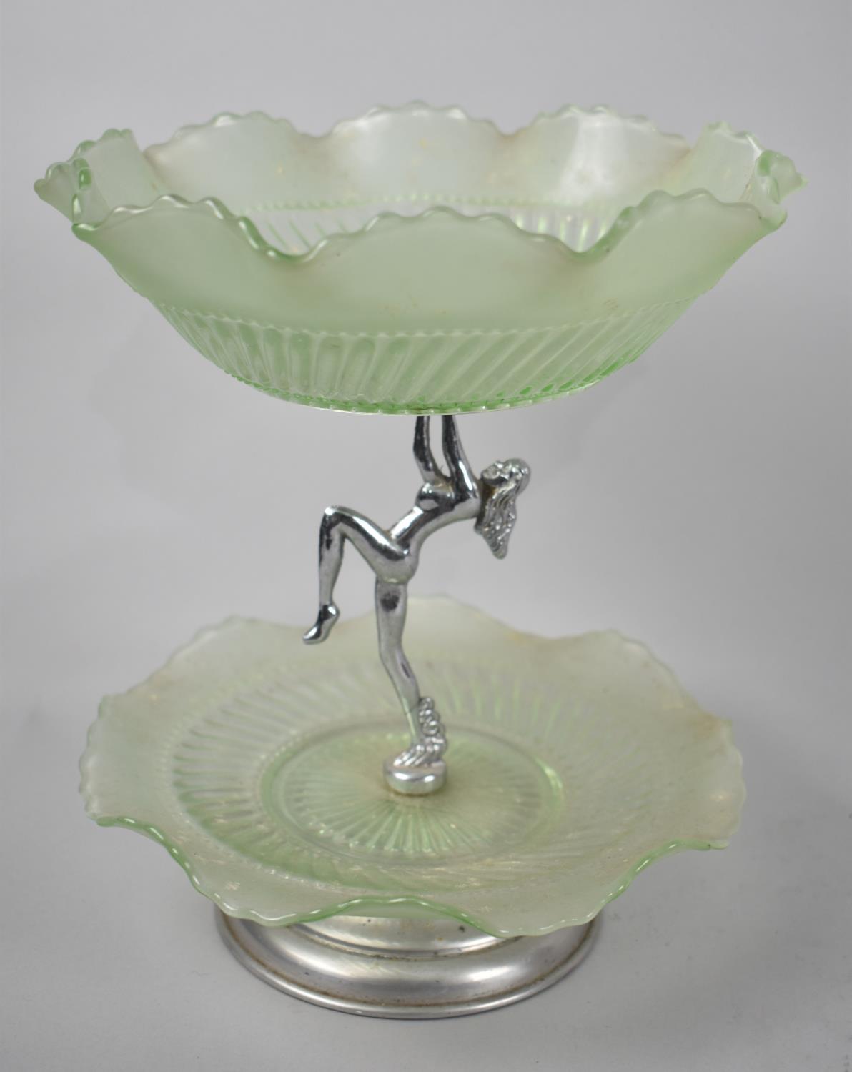 A Continental Green Glass and Chrome Two Tier Stand, Support in the Form of a Nude Maiden, 24cms