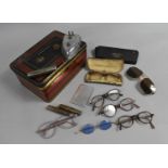 A Vintage Tin Containing Spectacles, Sunglasses, Penknife, Travelling Corkscrew etc