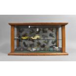 A Mid 20th Century Glazed Oak Display Case housing a collection of Small Die-Cast Vintage Cars,