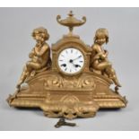 A Gilded French Bronze Figural Mantle Clock with Seated Boy and Girl Holding Musical Instruments,