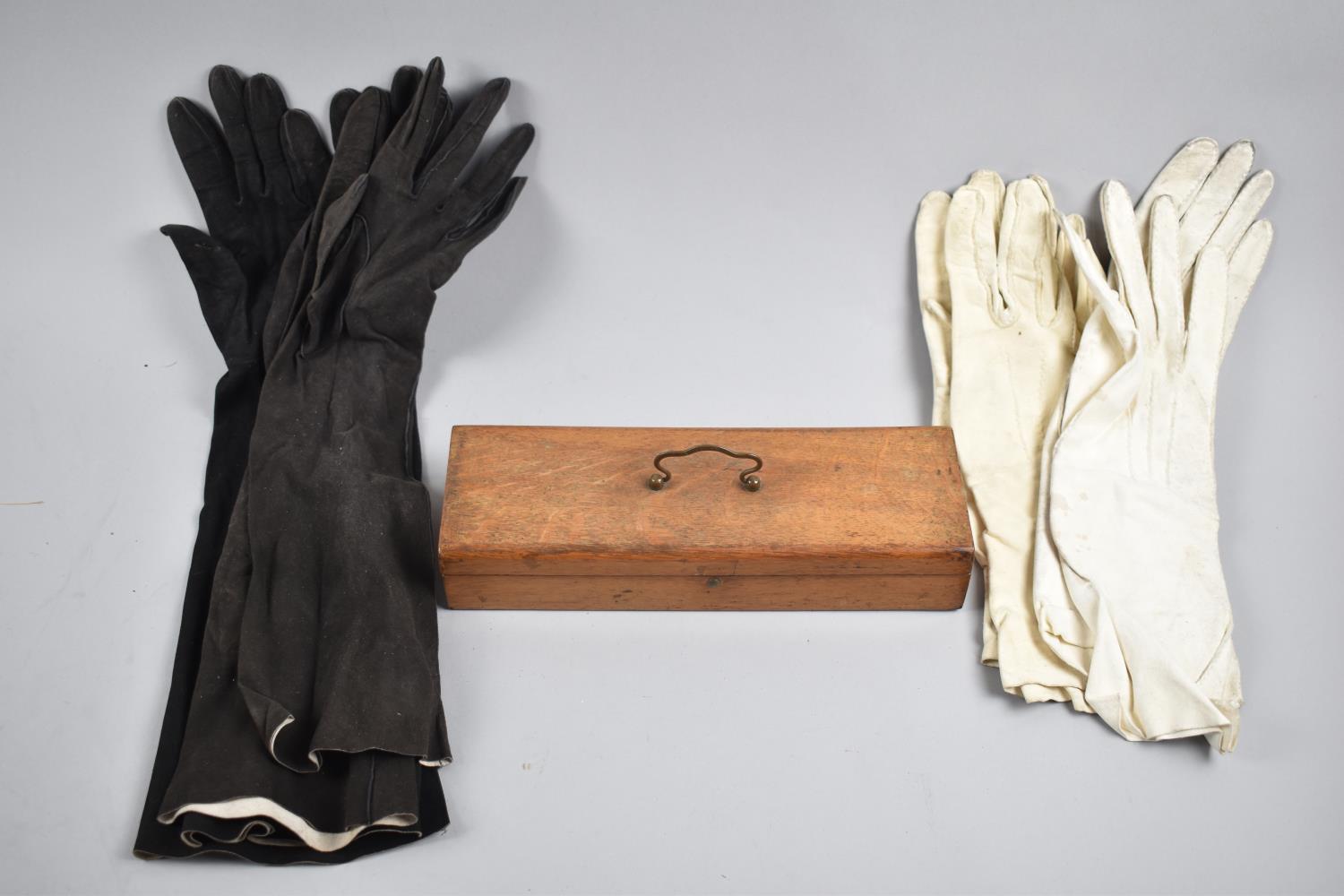 An Edwardian Oak Glove Box together with Four Pairs of Kid Gloves