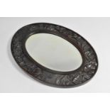 An Edwardian Carved Oval Mirror, 42.5cms High