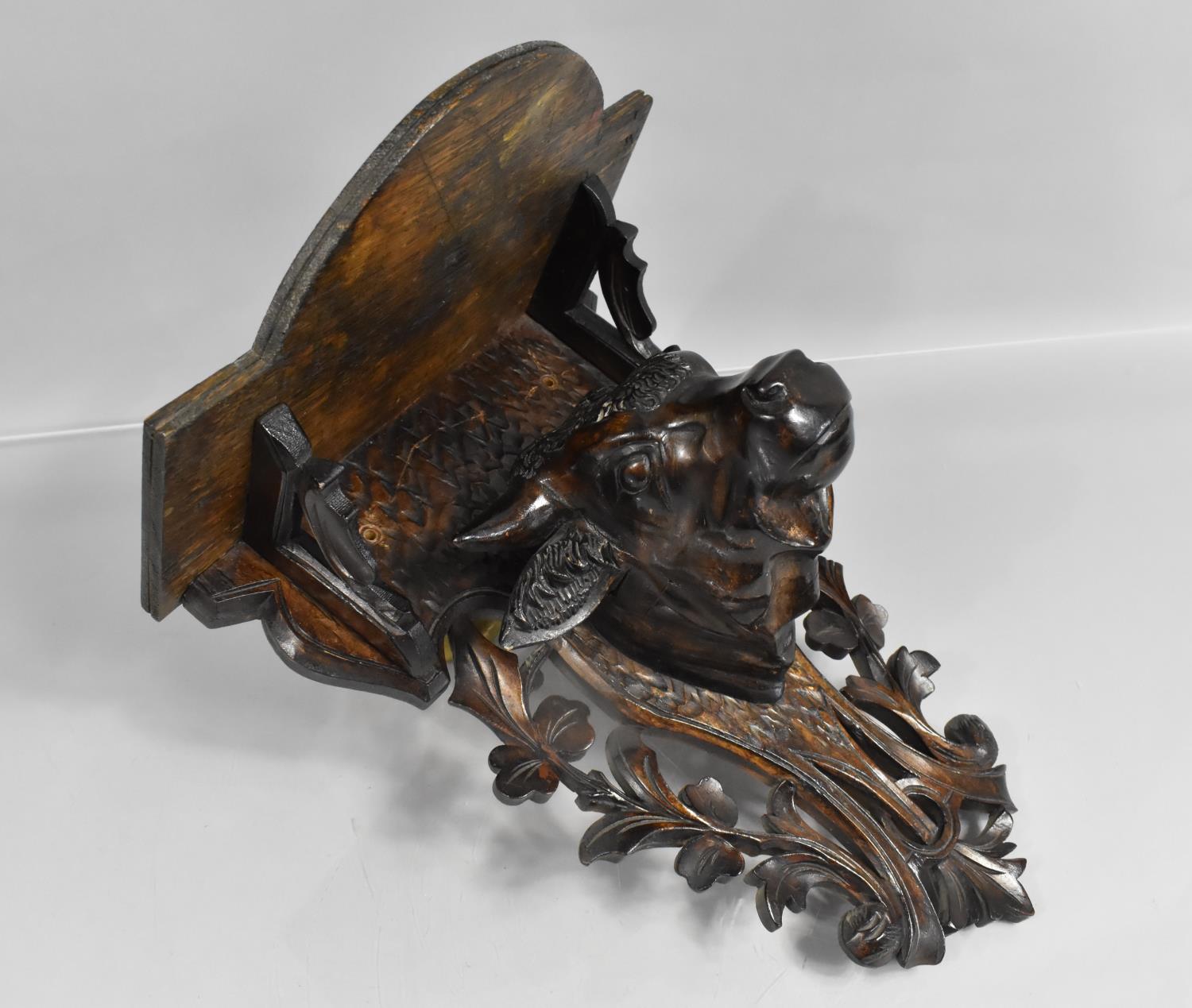 An Early 20th Century Carved Black Forest Wall Shelf with Bulls Head, Pierced Back Plate, 28cms Wide