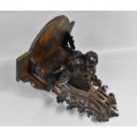 An Early 20th Century Carved Black Forest Wall Shelf with Bulls Head, Pierced Back Plate, 28cms Wide