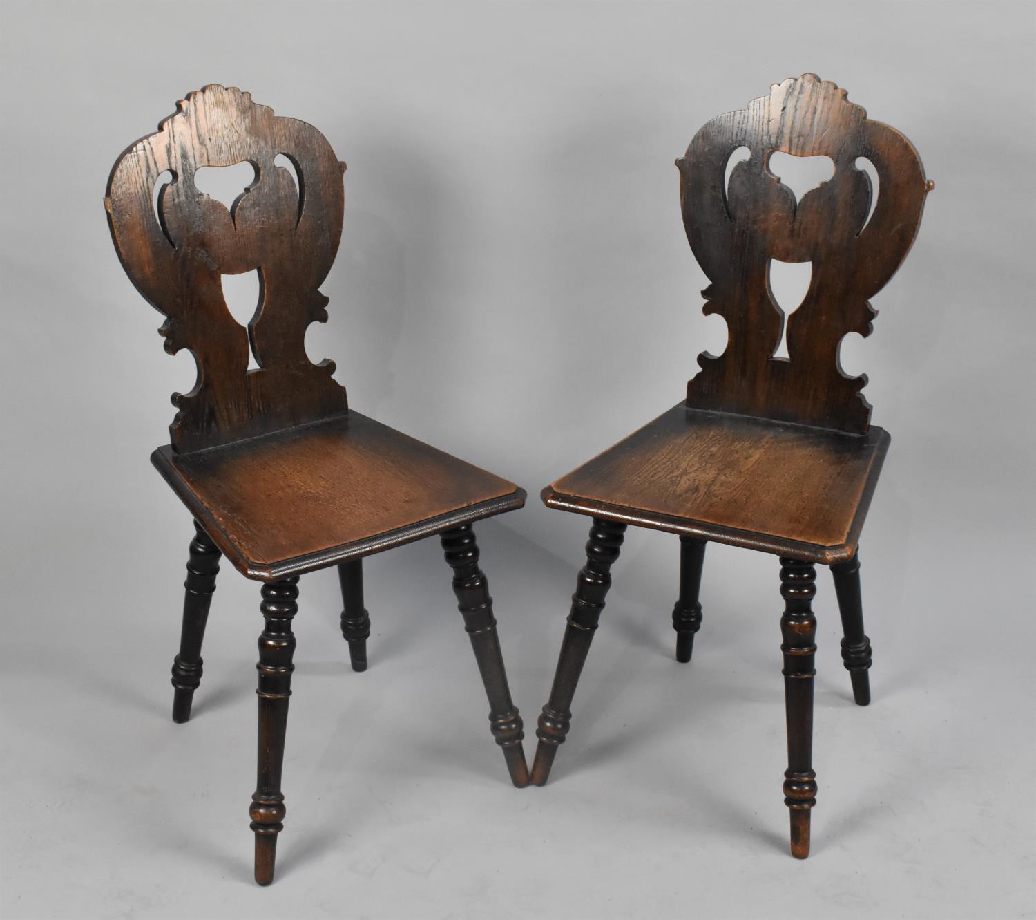 A Pair of Mid 20th Century Pierced Oak Hall Side Chairs on Turned Supports