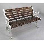A Wooden Slatted Cast Iron Bench, the Ends of Scrolled Form with Urn and Floral Design, 126cms Wide