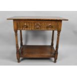 A Mid 20th century Oak Side Table with Single Carved Drawer and Turned Supports, Stretcher Shelf,