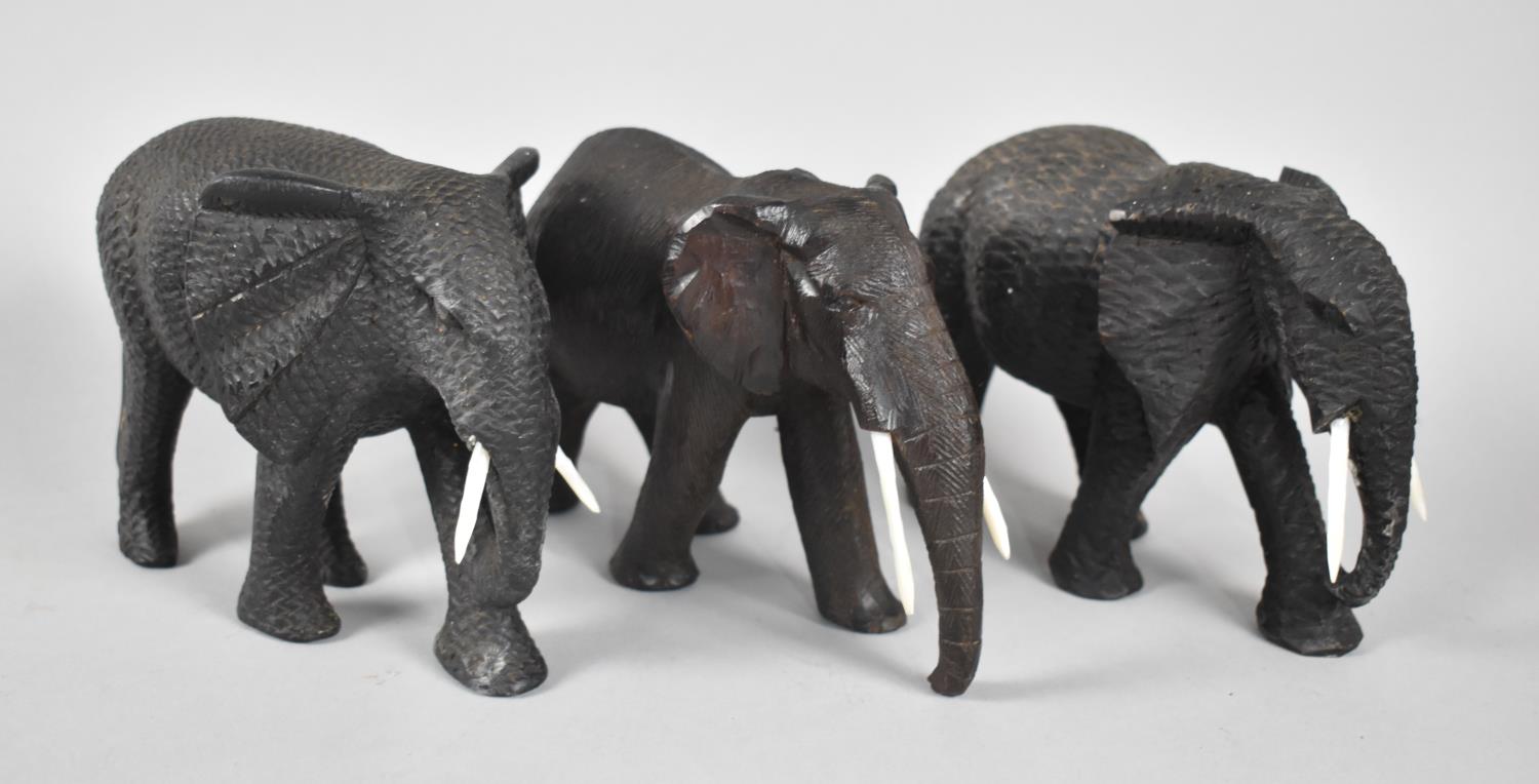 Three Carved Wooden Elephants, All with Mother of Pearl Tusks, tallest 12cms High