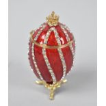 A Novelty Jewelled and Enamel Box in the Form of a Russian Egg on Tripod Scrolled Feet, 7.5cms High