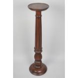 A Modern Mahogany Circular Topped Torchere Stand with Tapering Ribbed Support, 101cms High