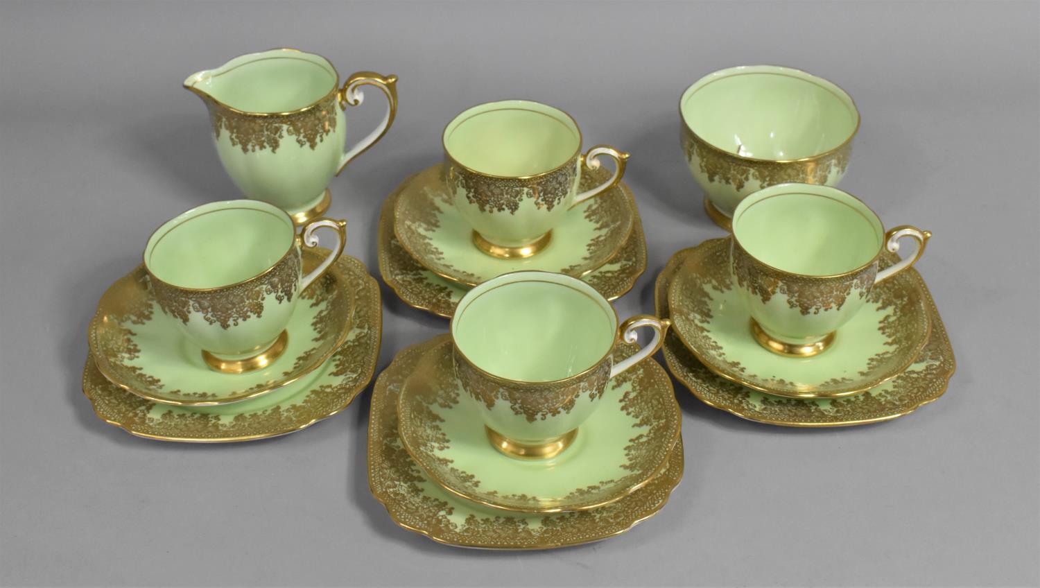 A Bell China Green and Gilt Foliate Lace Trim Part Teaset to Comprise Four Cups, Saucers, Side