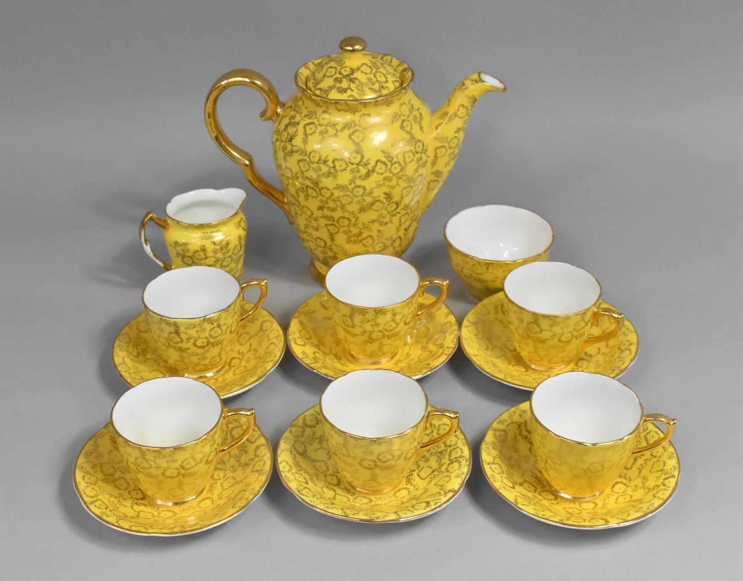 An English Bone China Laurie & Co. Coffee Set for Six Decorated with Gilt Foliage on Yellow Ground