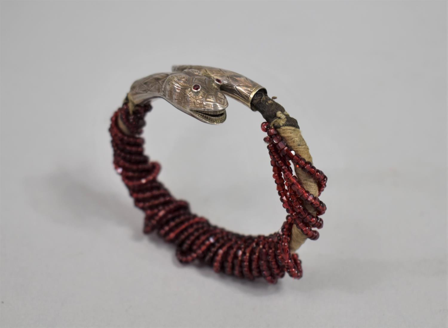 A Far Eastern White Metal Mounted Bangle with Snake Head and Tail