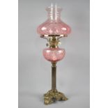 A 20th Century Brass Oil Lamp with Ribbed Column Support having Tinted Glass Reservoir and Shade,