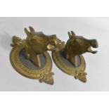 A Pair of Brass Wall Brackets in the Form of Horses Heads, 22cms Wide